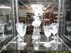 A engraved glass liquor jug and a set of six glasses.