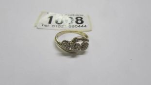 A three stone diamond ring, size O. 2.1 grams.