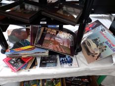 A quantity of LP's, 45's and unopened CD's including Queen, Fleetwood Mac, Bowie etc