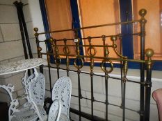 A Victorian brass and iron bedstead, 4'6" wide. COLLECT ONLY.