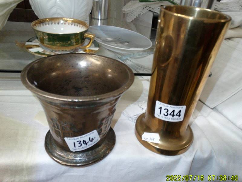 A heavy brass vase and an old mortar.
