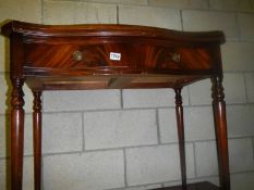 A mahogany serpentine front fold over hall table. COLLECT ONLY.