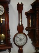 A Victorian wheel barometer with porcelain dial and swan neck pediment, COLLECT ONLY.