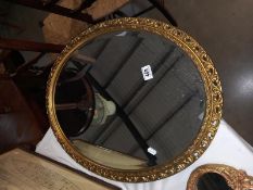 An oval gilt framed bevel edge mirror