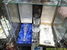 Two boxed crystal commemorative glasses and two others.