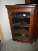 A Victorian oak corner cupboard with glazed door. COLLECT ONLY.