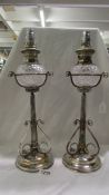 A pair of Victorian silver plated oil lamps by Hukin & Heath.