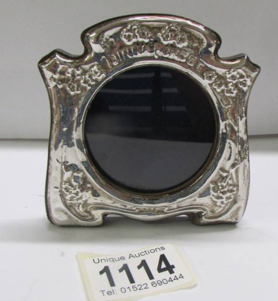 A small silver photo frame, 9 x 8 cm.