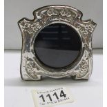 A small silver photo frame, 9 x 8 cm.