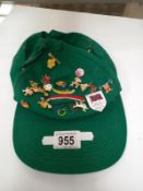 A green cap covered with badges