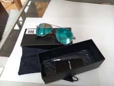 A boxed pair of Pukclar sun glasses