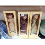 3 boxed porcelain doll's