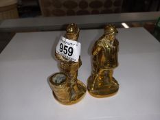 A matching pair of early 20th century solid brass match holders in the shape of Firemen