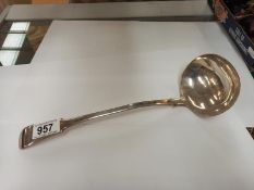 A long silver plate ladle