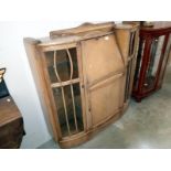 A bow front glazed writing desk with lockable doors/ key