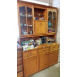 A teak style glazed wall unit