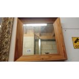 A small pine framed mirror. 39cm square