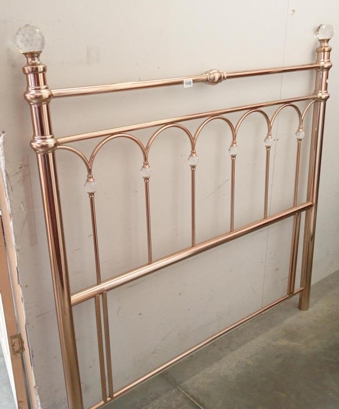 A brass effect double headboard