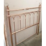 A brass effect double headboard