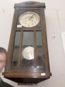 An oak glazed pendulum clock, still swinging