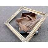 A large gilt picture frame and a box of vintage coat hangers