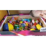 A box of Kinder egg toys and other bits.