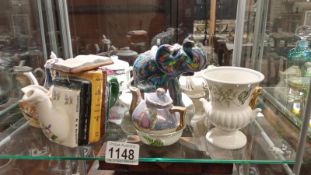 A quantity of cabinet miniature teapots etc