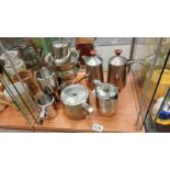 A quantity of metal items, jugs, teapot, coffee pot.