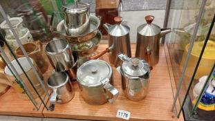A quantity of metal items, jugs, teapot, coffee pot.