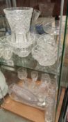 A mixed lot of glassware, jugs, vases and glasses etc. 2 shelves