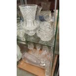 A mixed lot of glassware, jugs, vases and glasses etc. 2 shelves