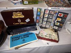 A small lot of stamps includes Stanley Gibbons cover album