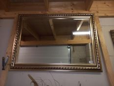 A large gilt framed bevel edged mirror, 107 x 77cm, COLLECT ONLY.