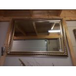 A large gilt framed bevel edged mirror, 107 x 77cm, COLLECT ONLY.