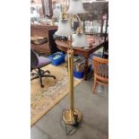 A brass floor lamp with 3 bulbs