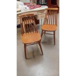 A pair of blonde Ercol style chairs
