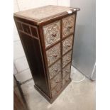 A decoratively carved 10 drawer cabinet.