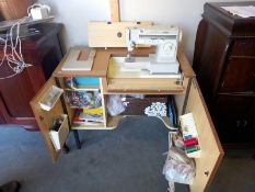 An electric sewing machine in cabinet with contents. Collect Only.