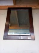 A bevel edged mirror in oak frame. COLLECT ONLY.