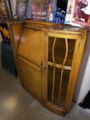 A bow front glazed writing desk with lockable doors/ key. Collect Only.