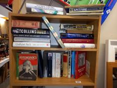 3 shelves of books including Stephen Hawking, Little Women, Hitchcock etc