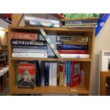 3 shelves of books including Stephen Hawking, Little Women, Hitchcock etc