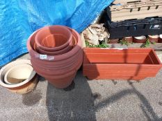A quantity of brick red plastic plant pots, troughs & 2 ceramic pots. Collect Only