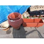A quantity of brick red plastic plant pots, troughs & 2 ceramic pots. Collect Only