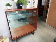 A 4 shelf solid wood display cabinet with sliding glass door front. 92cm x 28cm x 101cm.