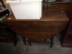 An oak gateleg oval table. Collect Only.