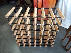 A wood and metal strap wine rack. 62cm x 23cm x 62cm. Collect Only.