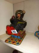 A vintage Japanese battery operated bear in tinplate rocking chair. Battery terminals corroded.