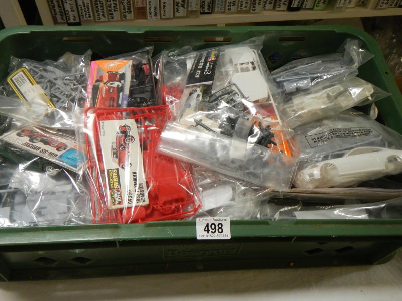 Approximately 28 plastic car model kits. No boxes or instructions, unchecked
