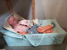 An old/mid 20th century doll A/F with carry cot